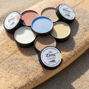Natural zinc sunscreen tins displayed on surfboard - 100% mineral broad spectrum protection