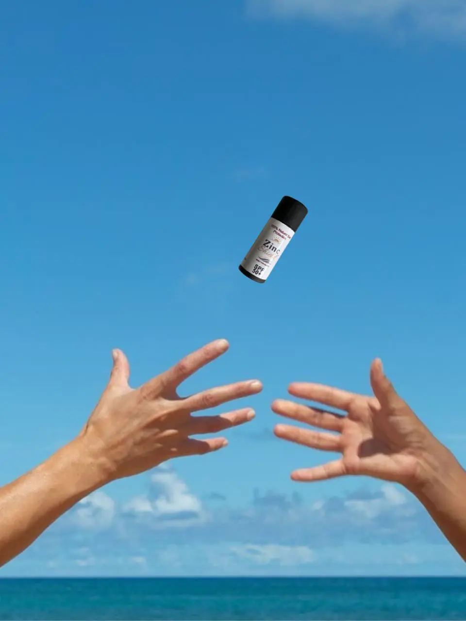 Fun lifestyle shot of Zinc Shield natural sunscreen bottle - lightweight portable mineral protection