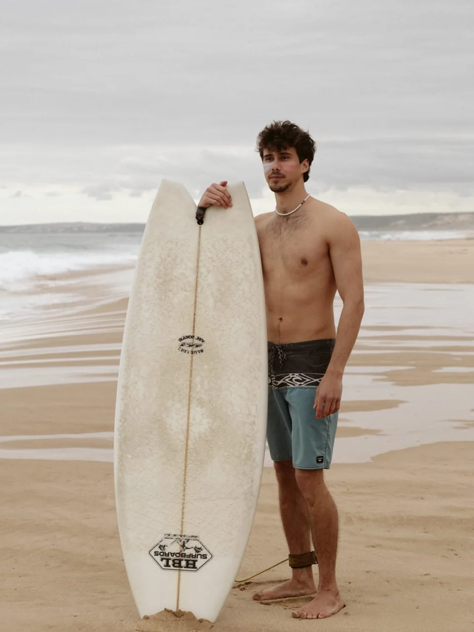 zinc-shield-sunscreen-surfer-with-surfboard-beach